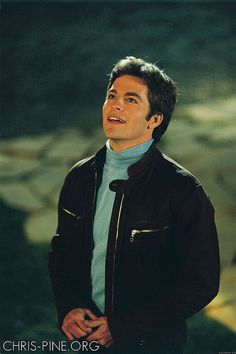 a man in a blue shirt and black jacket