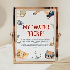 a sign that says, my water broke on the side of a bed with other things around it