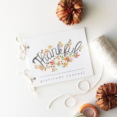 a thank you card surrounded by twine and other crafting supplies on a white surface