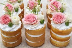 there are four cakes with flowers on top