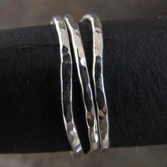 These delicate looking stacking rings are made of non-tarnish argentium sterling silver. Each one is hand made by me and they are made to order. They will never look exactly like the picture, but close. Almost always, I get all my orders out the day following your order. Individually the rings measure about 1.5mm wide. they are also available unwonkified in a set of 3: http://www.etsy.com/listing/81059502/skinny-hammered-silver-stack-rings-set or 5 - http://www.etsy.com/listing/81059192/skinny-h Everyday Hand Forged Sterling Silver Stackable Rings, Dainty Hand Forged Sterling Silver Stackable Rings, Handmade Silver Minimalist Stackable Rings, Handmade Minimalist Silver Stackable Rings, Unique Hammered Silver Stackable Rings, Unique Silver Stackable Rings With Hammered Detail, Everyday Handmade Silver Stackable Rings, Handmade Minimalist Stackable Rings In Sterling Silver, Minimalist Handmade Sterling Silver Stackable Rings