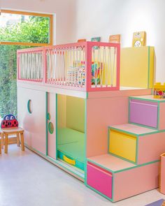 a child's bedroom with colorful furniture and stairs