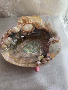 a bowl with shells and seashells on it