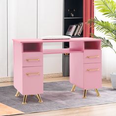 a pink desk with two drawers and a book shelf in the corner next to it