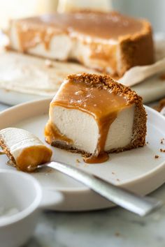 a piece of cheesecake with caramel sauce on it and a spoon next to it