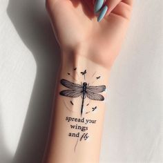 a woman's arm with a dragonfly tattoo on it and the words spread your wings and fly