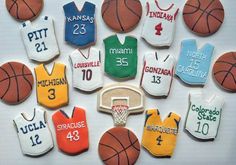 decorated cookies in the shape of sports jerseys and basketballs are arranged on a table