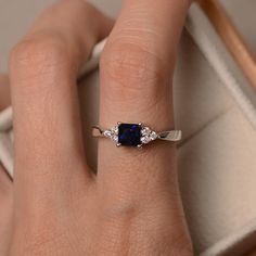 This ring features a 5*5mm princess cut lab sapphire and sterling silver finished with rhodium. Customization is available. It is made by hand, and it will take about 7 days to finish the ring after your payment is completed. Any question, just let me know. :) My shop homepage: https://www.etsy.com/shop/LuoJewelry?ref=l2-shopheader-name Classic Cubic Zirconia Radiant Cut Sapphire Ring, White Gold Sapphire Ring With Brilliant Princess Cut, Princess Cut Diamond Ring With Accent Stones For Promise, Anniversary Sapphire Ring Square Cut, Princess Cut Jewelry With Accent Stones, Classic Princess Cut Lab-created Sapphire Ring, White Gold Solitaire Sapphire Ring With Princess Cut, Luxury Square Cut Brilliant Sapphire Ring, White Gold Sapphire Ring Solitaire Princess Cut