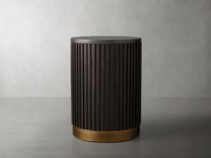 a black and gold trash can sitting on top of a table