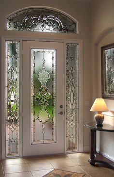 an entryway with a glass door and sidelights