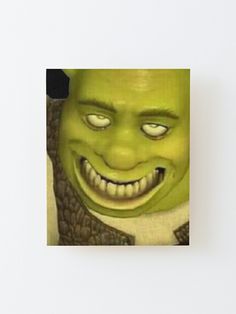 an image of a green man with big eyes and griny smile on his face