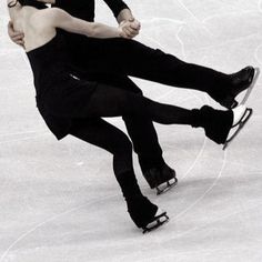 two people are skating on an ice rink