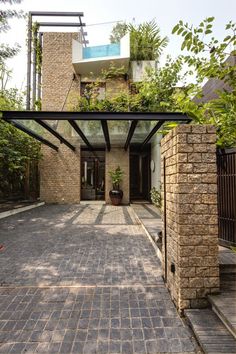 an entrance to a brick house with plants growing on the roof