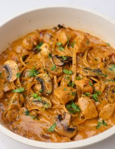 a white bowl filled with pasta and mushrooms