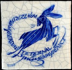 a blue and white tile with a rabbit on it's head in the center