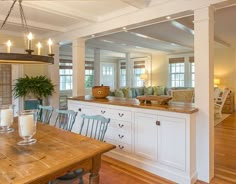 an open kitchen and living room with wood flooring