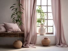 two vases sitting next to each other in front of a window with pink curtains