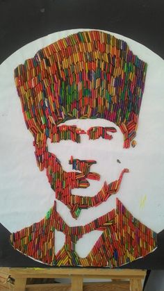 a paper collage of a man wearing a turban made out of crayons