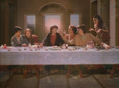 a group of people sitting at a long table