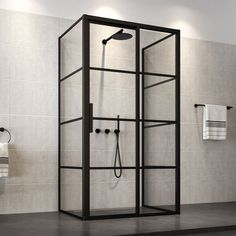 a bathroom with a stand up shower next to a toilet and towel racks on the wall