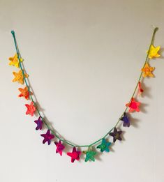 multicolored star garland hanging on white wall