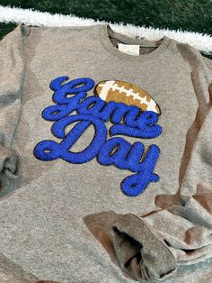 Show off your game day spirit in this cozy chenille patch sweatshirt! Tailgate in comfort and style with this must-have sweatshirt, in your favorite team colors! Go team! All Chenille Patches are sewn on! Not heat applied! Iron Patch Sweatshirt, Collegiate Sweatshirt For Game Day In Fall, Collegiate Style Sweatshirt For Game Day In Fall, Fall Varsity Sweatshirt With Team Logo, Collegiate Fleece Tops For Game Day, Collegiate Tops With Letter Patch For Game Day, Collegiate Tops With Letter Embroidery For Game Day, School Spirit Tops With Embroidered Logo For Game Day, Collegiate Letter Embroidery Top For Game Day