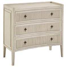 a white dresser with three drawers and two doors