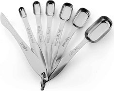 six stainless steel utensils are shown in the shape of a spoon and knife