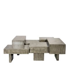 a concrete coffee table sitting on top of a white floor