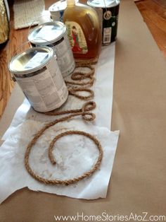 some cans are sitting on a table with rope