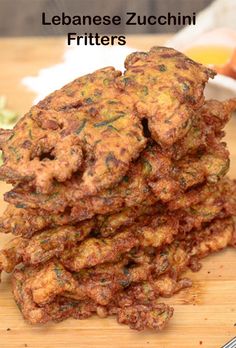 a pile of food sitting on top of a wooden cutting board