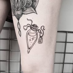 a woman's leg with a tattoo on it and an object in the middle