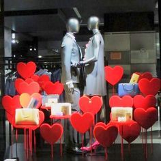 two mannequins dressed in black with red hearts