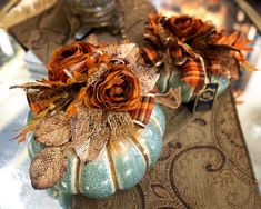 two decorative pumpkins sitting on top of a table