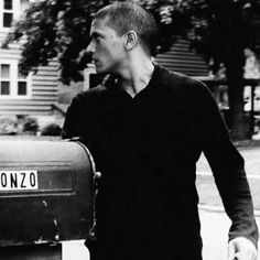 black and white photograph of man with mailbox