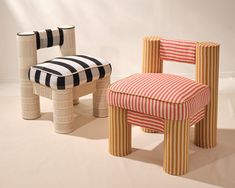 two chairs made out of toilet paper sitting next to each other on the floor in front of a white wall