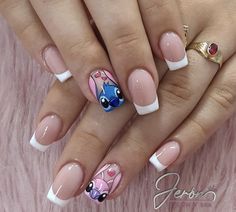 a woman's hands with french manies and nail designs on their nails,