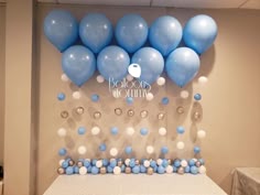 blue and white balloons are on the wall