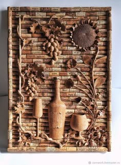 a wooden wall sculpture with vases, grapes and sunflowers