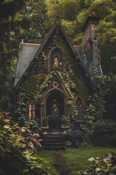 an old house with ivy growing all over it's roof and windows, surrounded by greenery