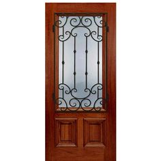 a wooden door with glass and wrought iron