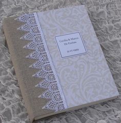 a book with lace on it sitting on a bed