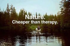 a man in a canoe on a lake with the words nature cheaper than therapy