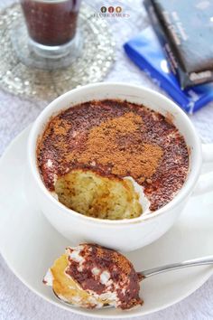 a white plate topped with a chocolate mug cake