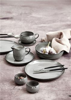 a table topped with plates and bowls filled with food