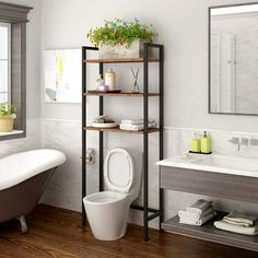 a bathroom with a toilet, sink and bathtub next to a window in it