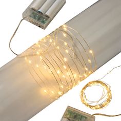 some lights that are on the side of a pole next to a remote control and wires