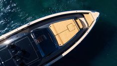 an overhead view of a small boat in the water with it's front end out