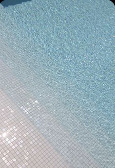 an empty swimming pool with clear blue water