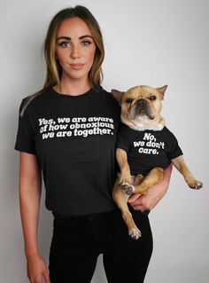 a woman holding a small dog wearing a t - shirt that says, you've always seen those dogs before they are together